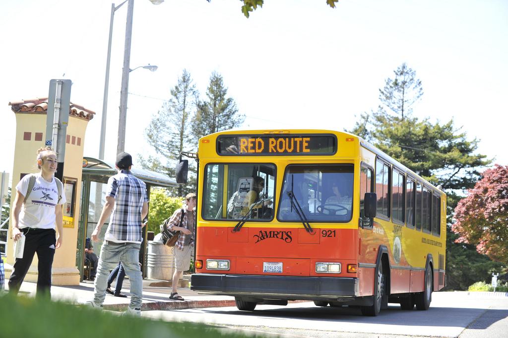 AMRTS Bus (orange and yellow) with Red Route on its route indicator